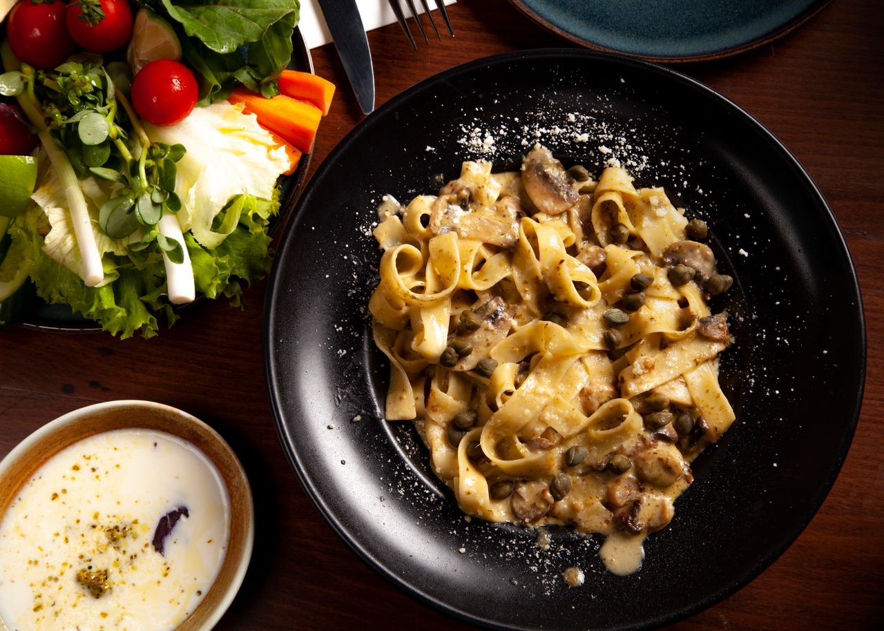 Savor the rich flavor of creamy mushroom pasta paired with a vibrant fresh salad.